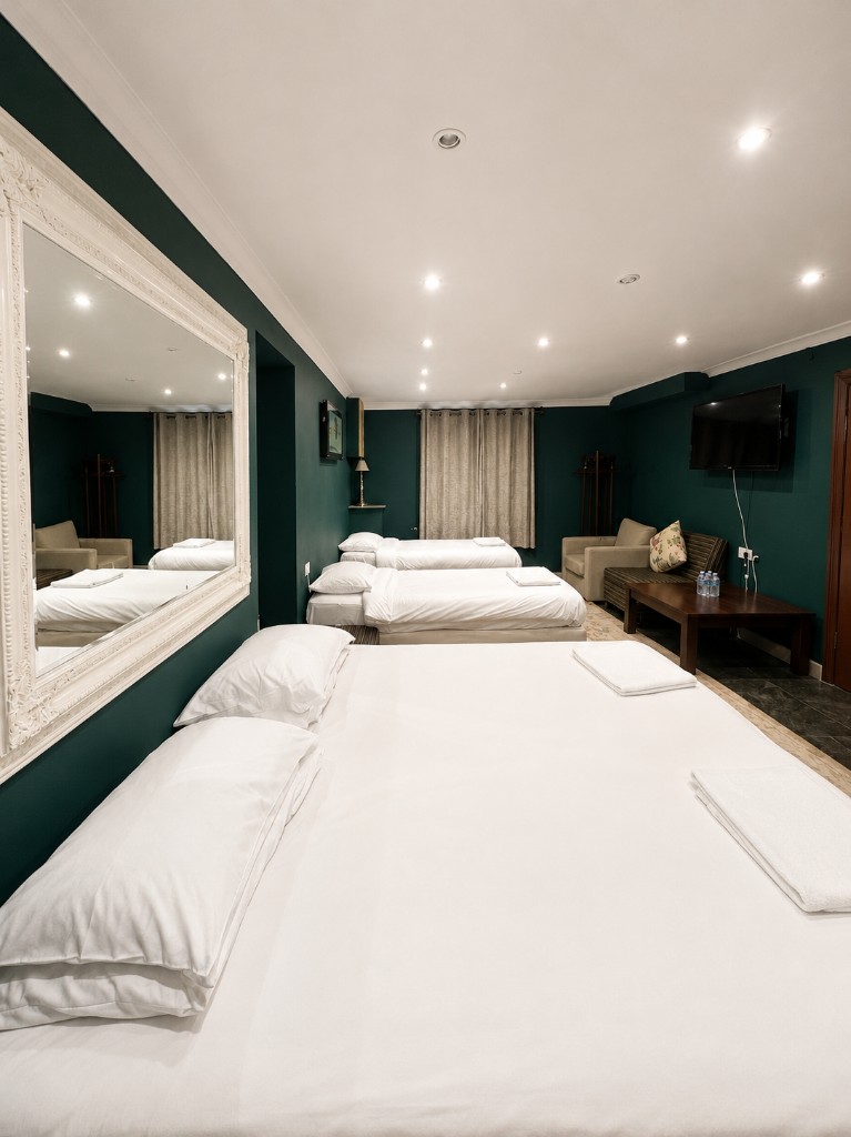 Family room with multiple beds and seating area